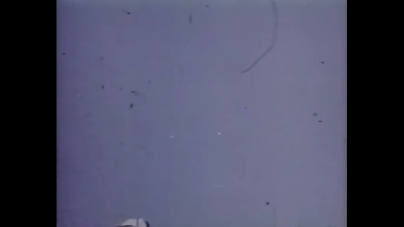 A frame from Nick Mariana's 16mm Kodachrome film of 15 August 1950 — two silvery discs passing over Great Falls, Montana, captured by the Selectrics' general manager.