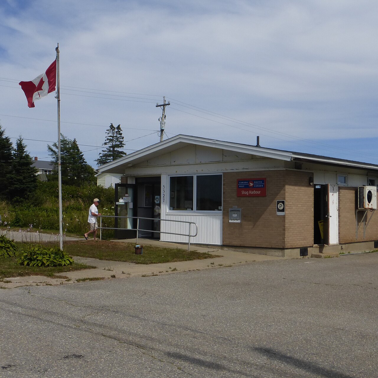 Modern Shag Harbour — the postal-station and harbour-front view; the case file remains officially open in the Library and Archives Canada records.