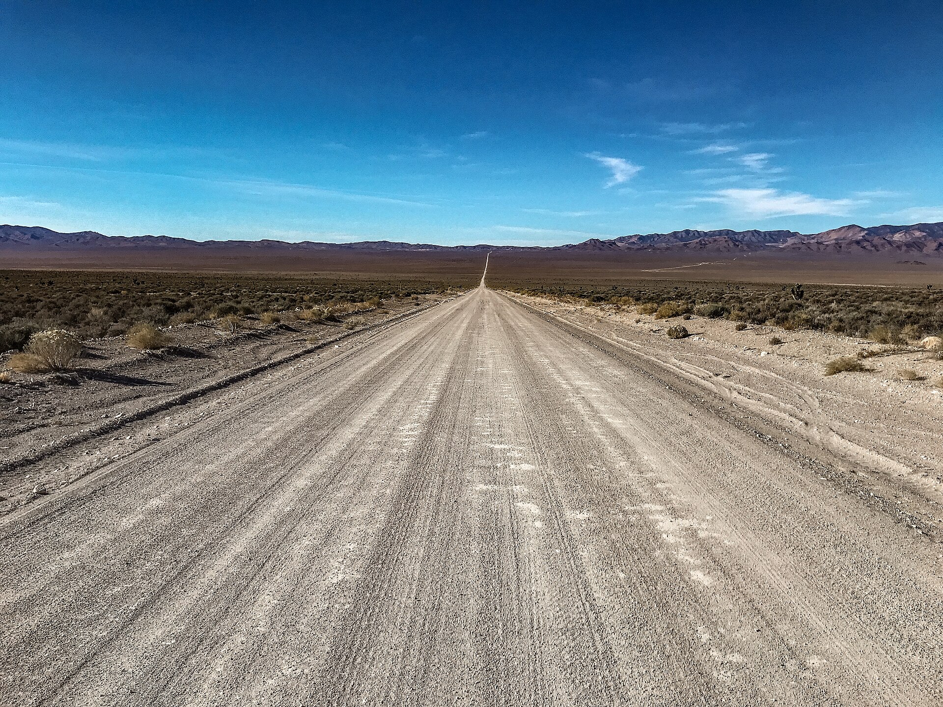 Groom Lake Road — the dirt track that leads to the back gate. The drive across the dry lakebed approach was where Bob Lazar said he was brought in November 1988 to work on 'sport model' craft.