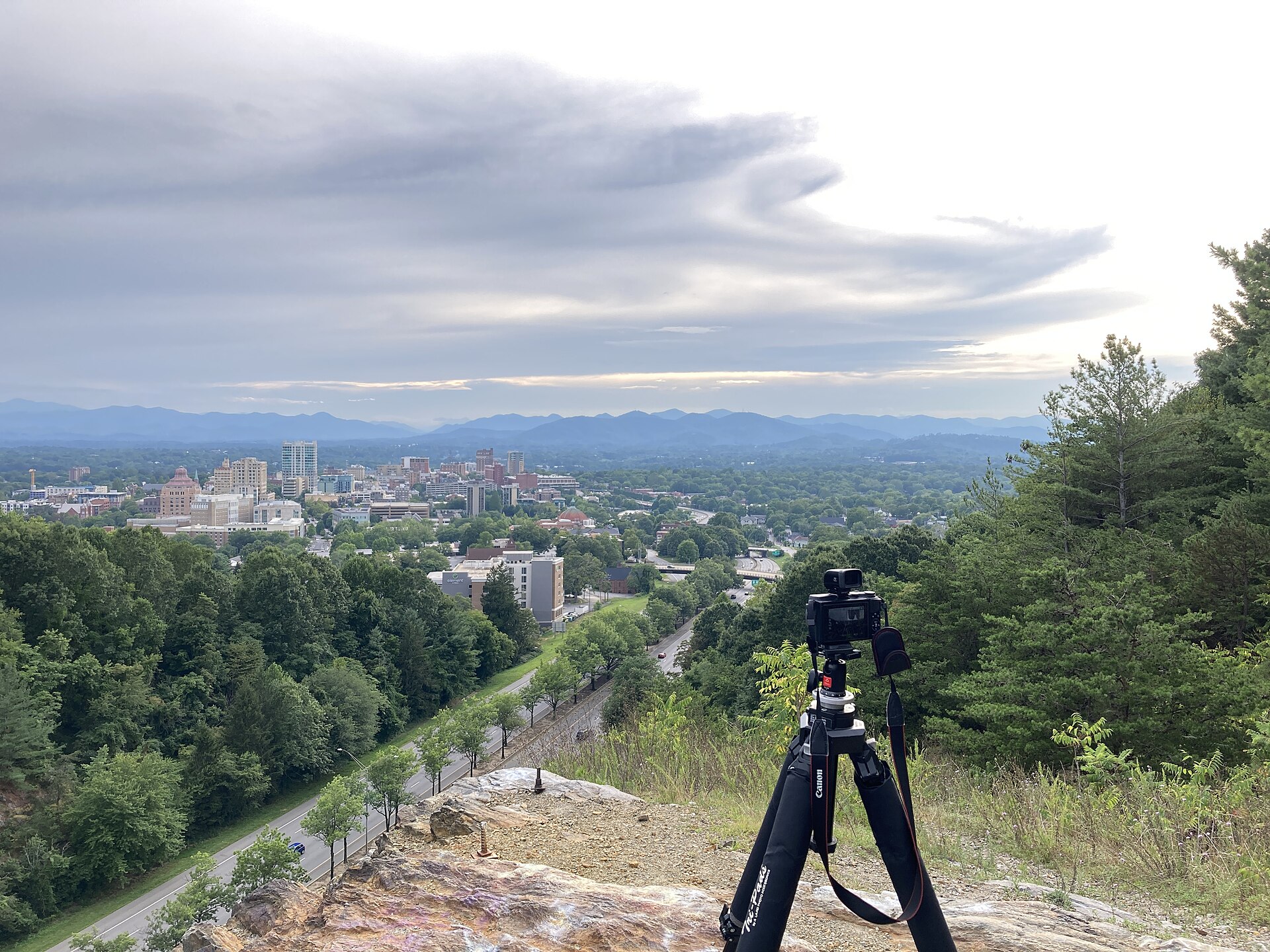 Downtown Asheville from Beaucatcher Mountain. The city sits at the confluence of the French Broad and Swannanoa Rivers — indigenous oral histories anchor settlement here for 11,000 years.
