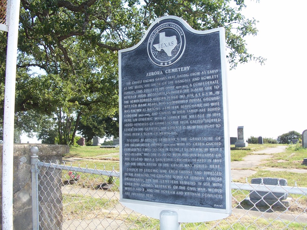 The Texas Historical Commission marker at Aurora Cemetery: 'This site is also well-known because of the legend that a spaceship crashed nearby in 1897 and the pilot, killed in the crash, was buried here.' The state acknowledges the story even as it qualifies it.