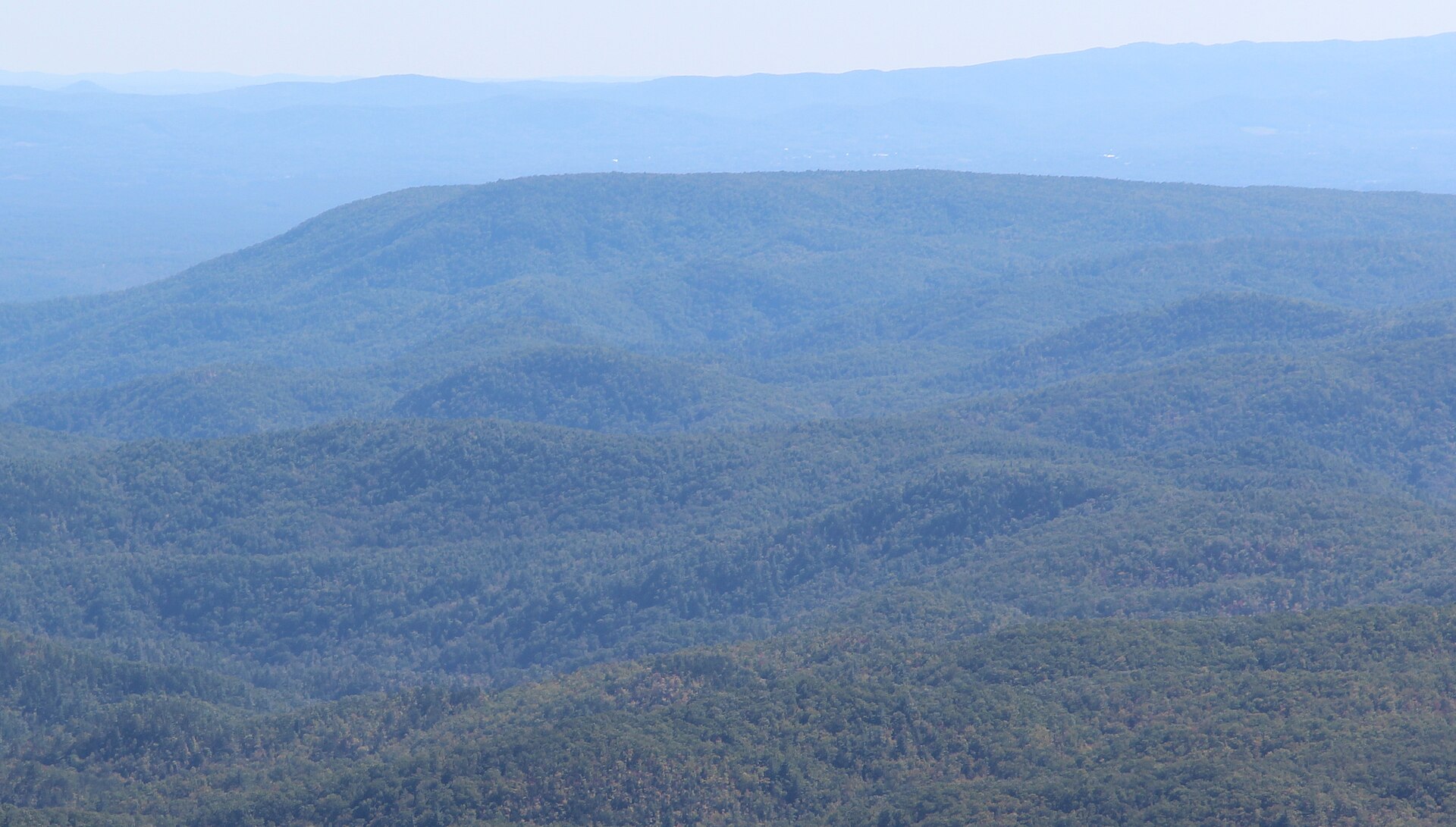 Brown Mountain, North Carolina — viewed from Beacon Heights on the Blue Ridge Parkway. The Cherokee told German immigrants of luminous spirits dancing along the ridge centuries before the first written 1771 account by surveyor Gerard Will de Brahm.