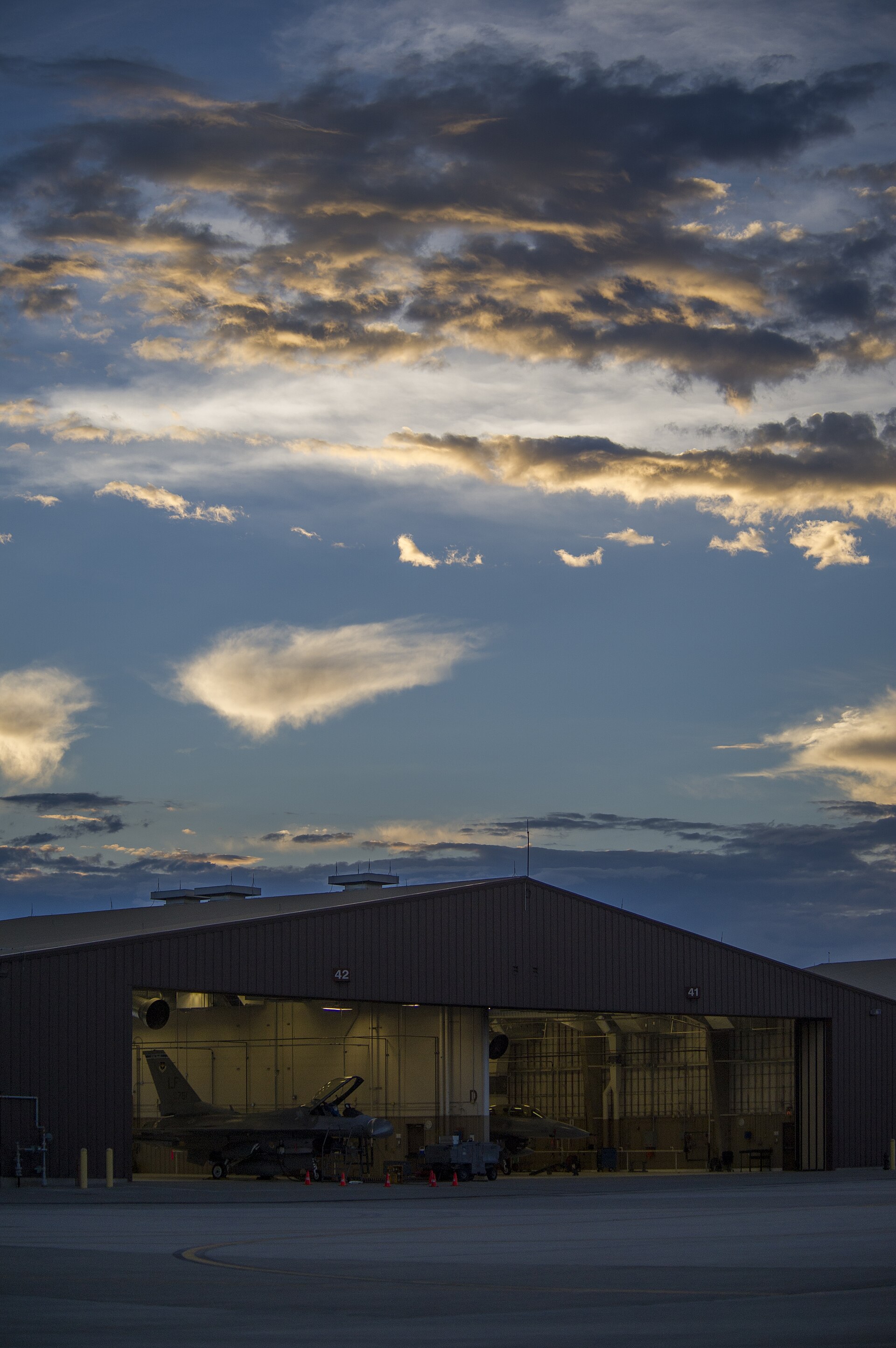 A Holloman hangar at twilight. The base lies on the western flank of White Sands Missile Range — the closest active USAF installation to the Trinity test site of July 1945.