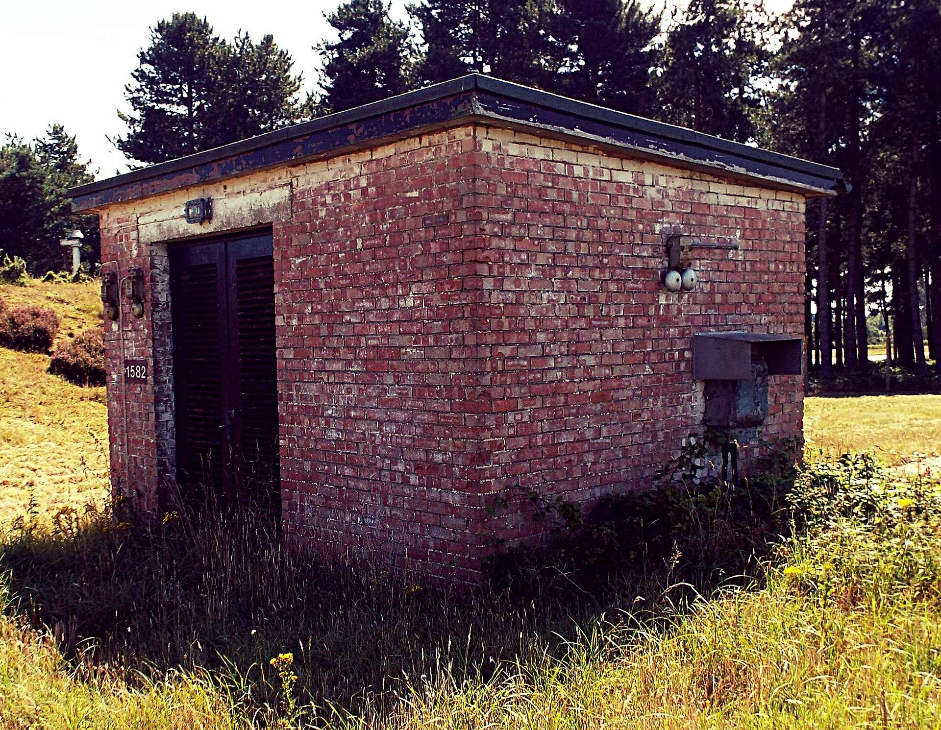 A surviving building at RAF Bentwaters — the USAF-leased airbase from which Penniston, Burroughs, and Halt entered the forest. The base closed in 1993; the buildings stand empty on the heath.