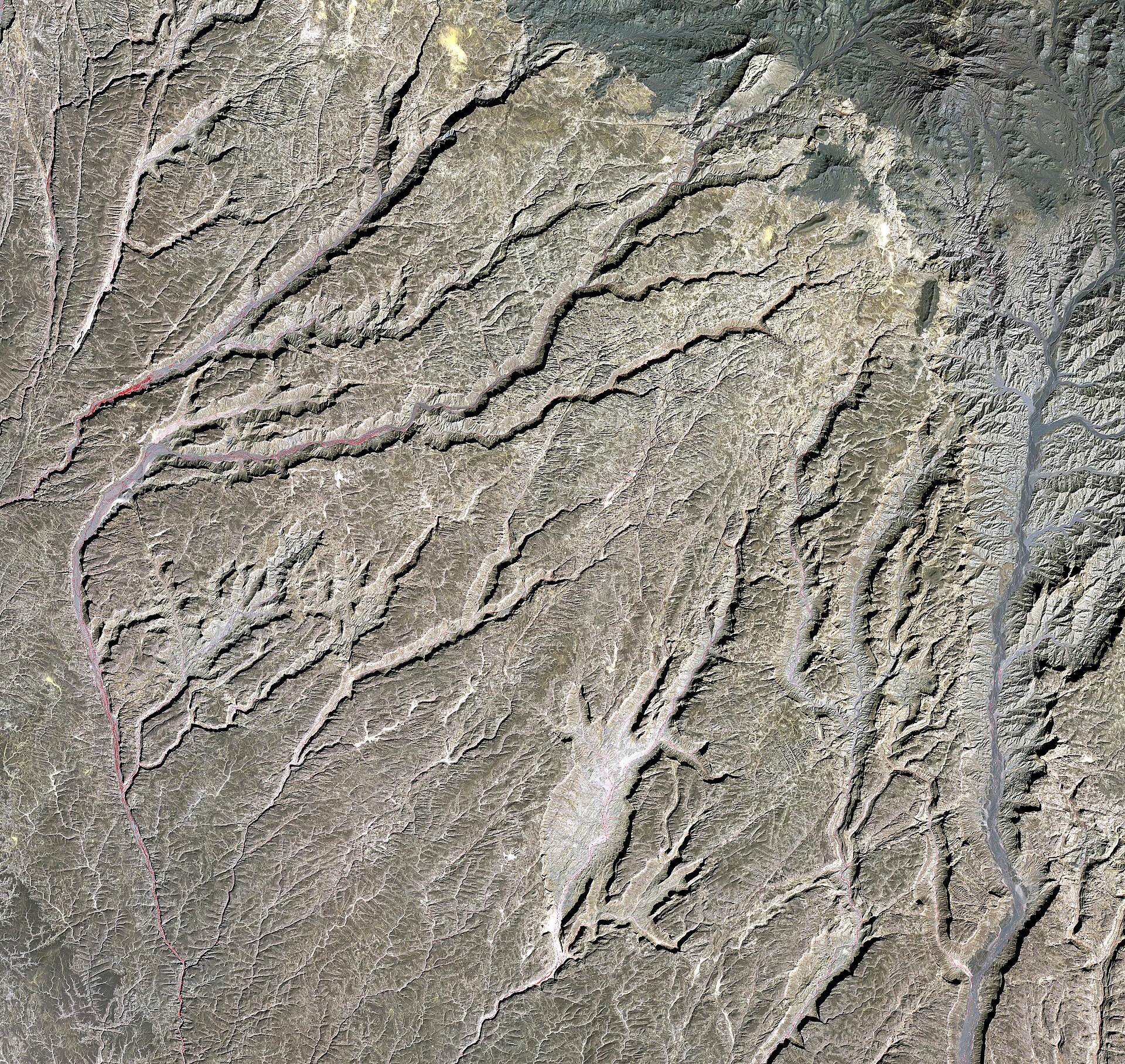 ASTER satellite image of the Tibesti Range — the calderas of Emi Koussi and Tarso Toussidé are visible as dark concentric rings. The hot-spring fumaroles in the central range mark active geothermal venting; thermal anomalies are detectable from orbit.