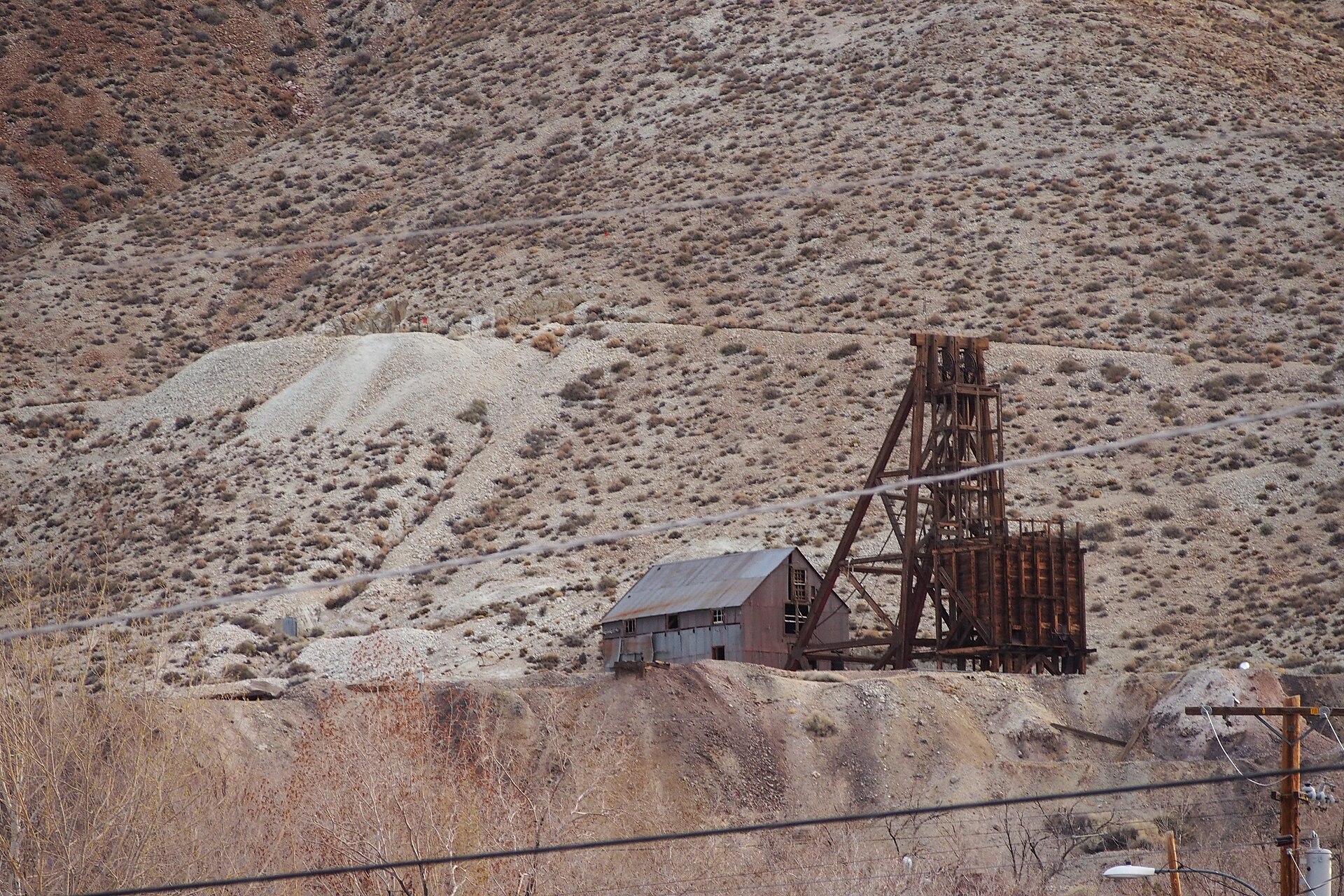 The Desert Queen Mine, Tonopah — one of the silver shafts that built the town. The boom of 1900-1920 funded the Mizpah Hotel and the streets that still mark the basin floor. By the 1940s the silver was gone and the town was almost empty when the AEC moved in.